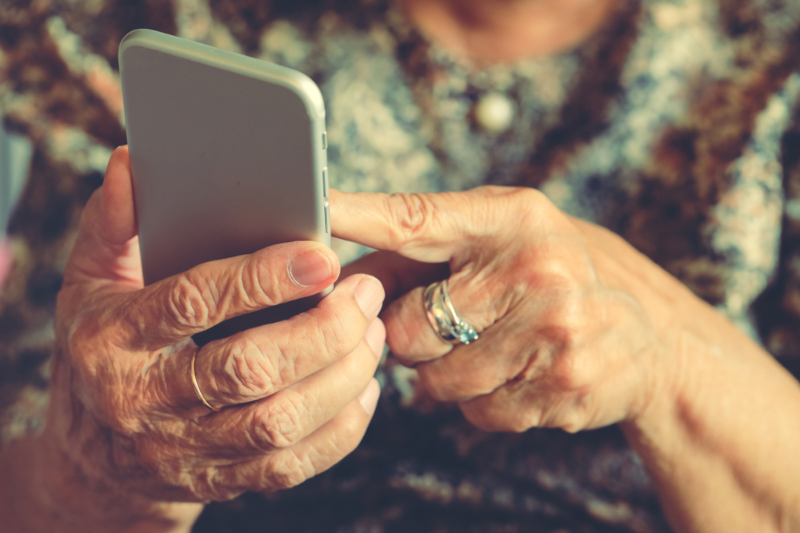 Hands,Of,An,Elderly,Woman,Holding,A,Mobile,Phone