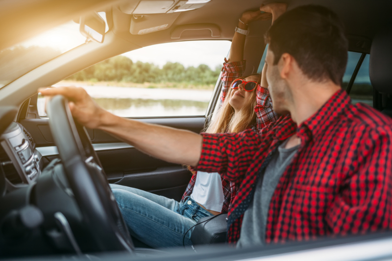 Couple,Sitting,In,The,Car,Listening,To,Music,And,Having