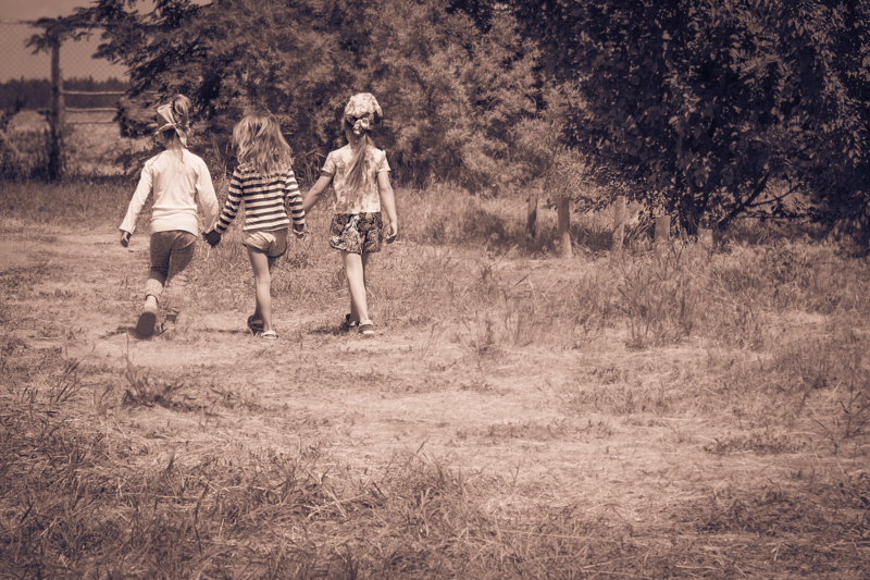 Three,Little,Girls,Walking,Outdoors,Holding,Hands.,Girlfriends,Or,Sisters.