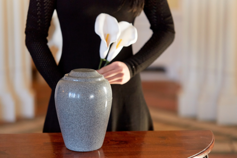 Cremation,,People,And,Mourning,Concept, ,Woman,With,Flowers,And