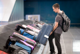 Young Man Collecting His Luggage