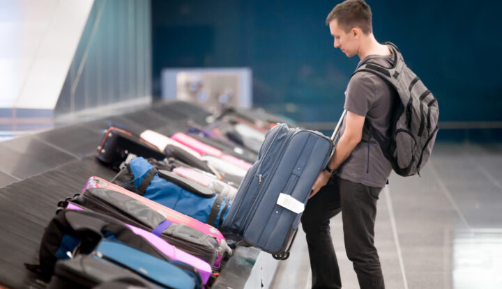 Young Man Collecting His Luggage